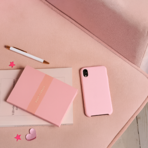 Pink Desk Setup with Notebook and Vials